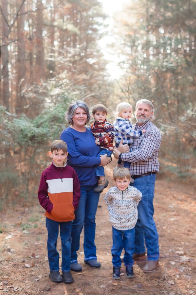 Group family portrait in wooded area at Jetton Park during fall.