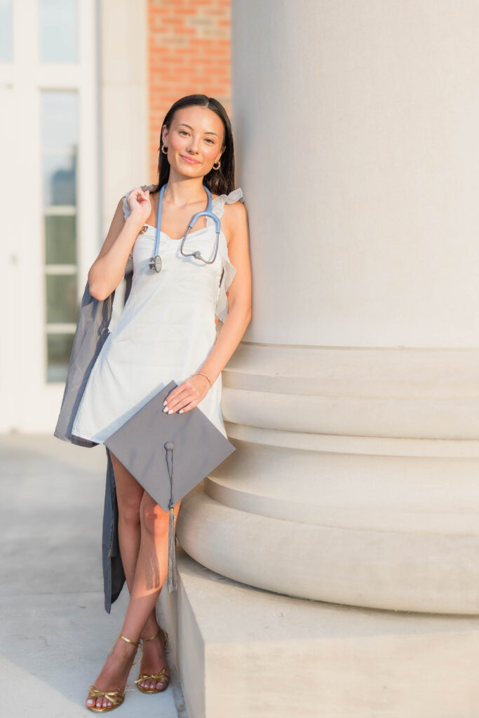 Charlotte graduation photographer captures CPCC grad Mika with cap and gown.